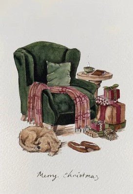 Christmas card with green armchair, dog resting, and wrapped gifts — cosy countryside warmth.