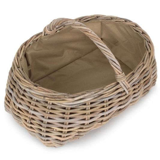 Interior of grey rattan log basket showing durable Cordura lining — a practical, heritage-inspired detail for fireside storage and rustic organisation.