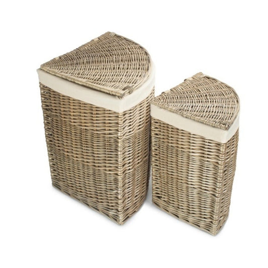 The Elmsmere Corner Keeper – handwoven antique wash willow laundry basket with removable white cotton lining, styled in a softly lit corner.