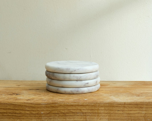 Belgravia Marble Coasters polished natural stone set arranged neatly in a pile