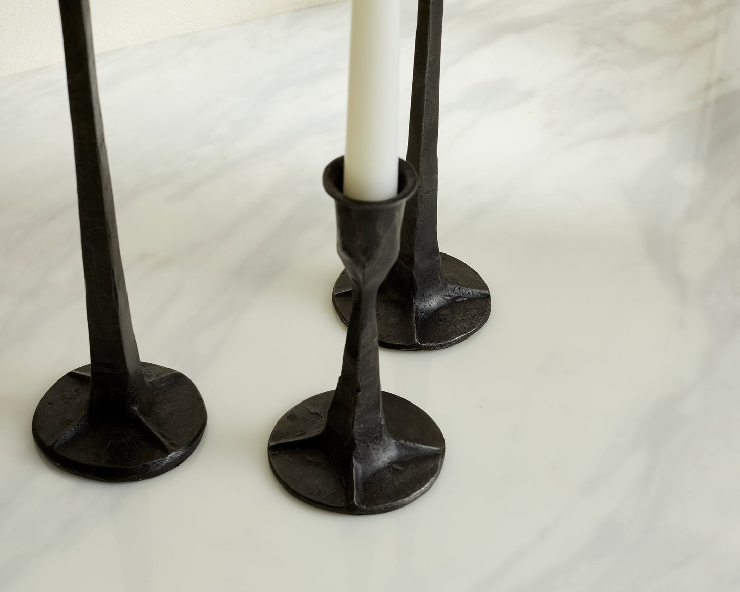 Close view of Bloomsbury Iron Black Candle Holder Set of 3 displayed on a table