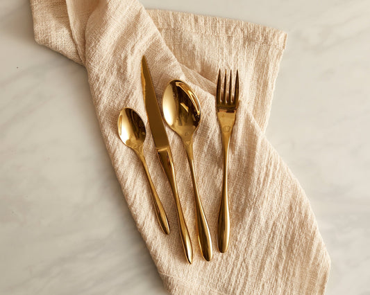 Hope's Haven gold cutlery set stainless steel flatware styled on a linen napkin
