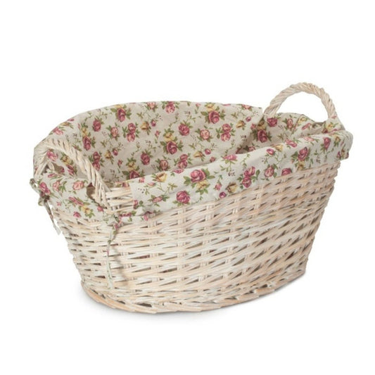 White wicker laundry basket oval shape with vintage rose floral lining on white background