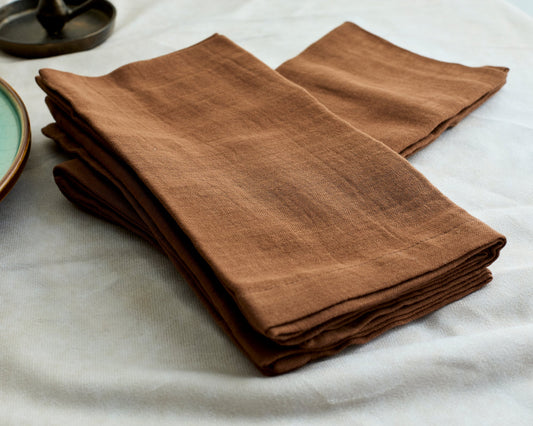 Muslin cotton napkins set of 4 Branwell Brown Rustic shown in a pile close view highlighting texture