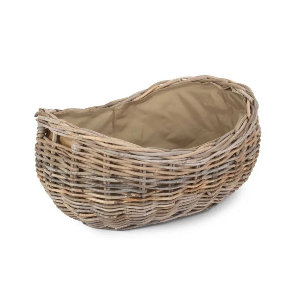 Large boat-shaped rattan log basket natural woven texture tan lining UK
