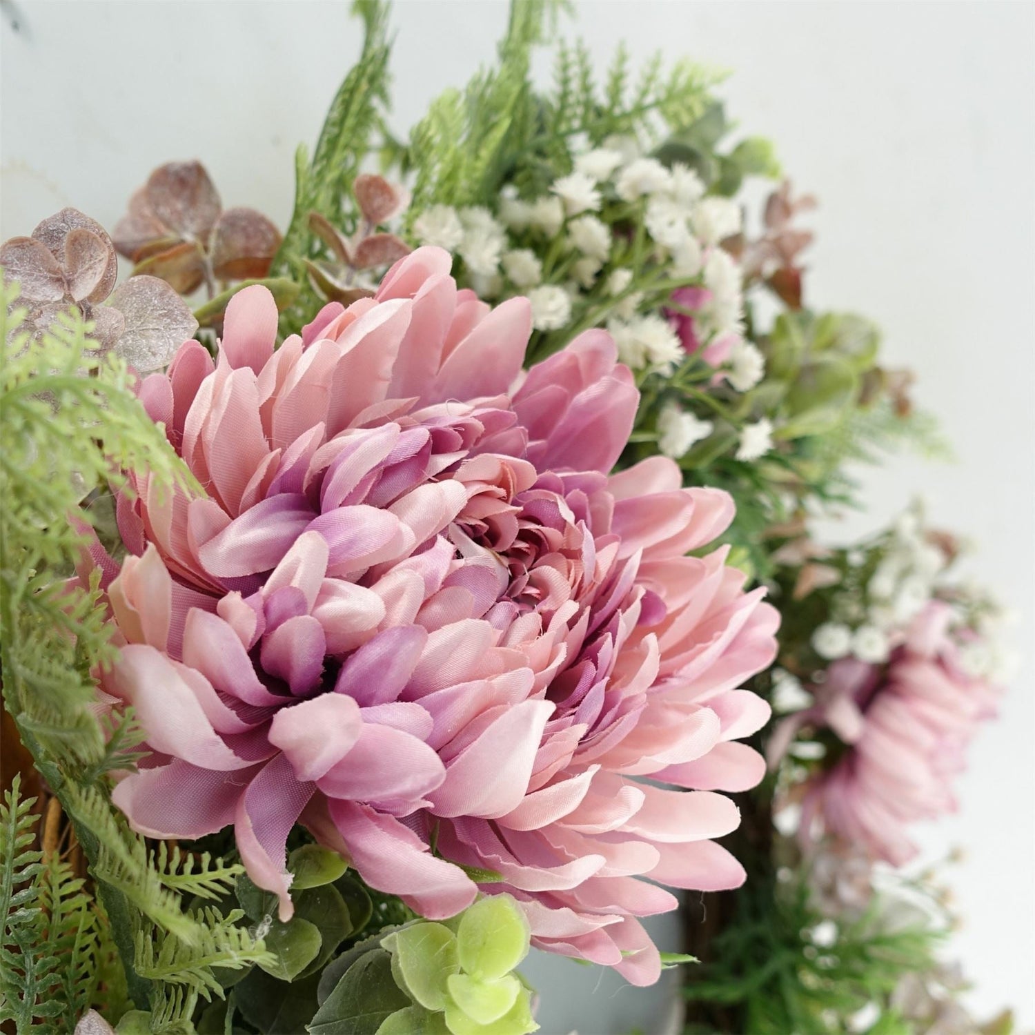 Realistic artificial plants and faux flowers for cottage homes including olive trees, eucalyptus stems, and botanical wreaths