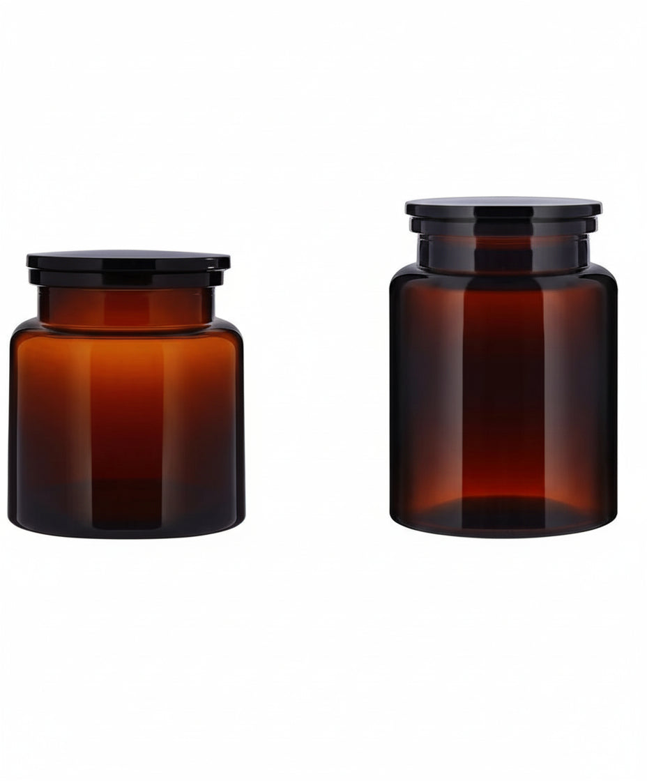 The Wetherby Amber Glass Storage Jar Duo – large and small apothecary-style jars in translucent amber glass with wide-mouth design, styled together for bath salts, cotton pads, or basin-side essentials.