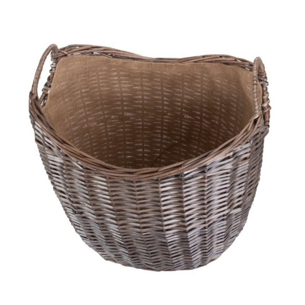 Inside view of wicker log basket with hessian lining — rustic, eco‑friendly fireside storage.