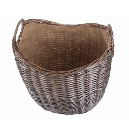 Inside view of wicker log basket with hessian lining — rustic, eco‑friendly fireside storage.