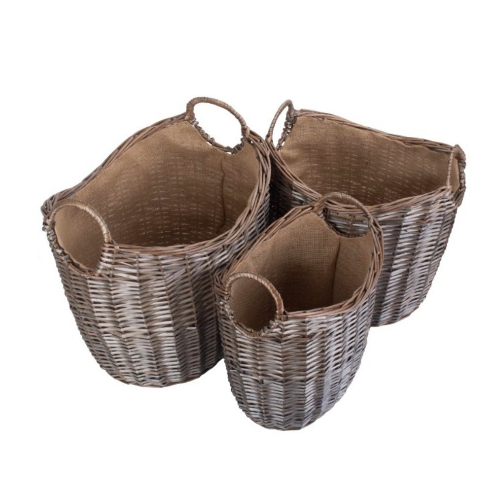 Set of 3 wicker log baskets with hessian lining on blank background — rustic, eco‑friendly fireside storage.