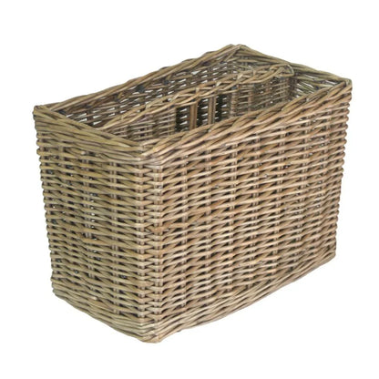Empty antique wicker magazine rack with slanted sides and woven design on white background