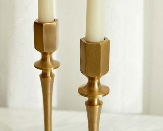 Handcrafted brass candlesticks gold finish close-up farmhouse table UK