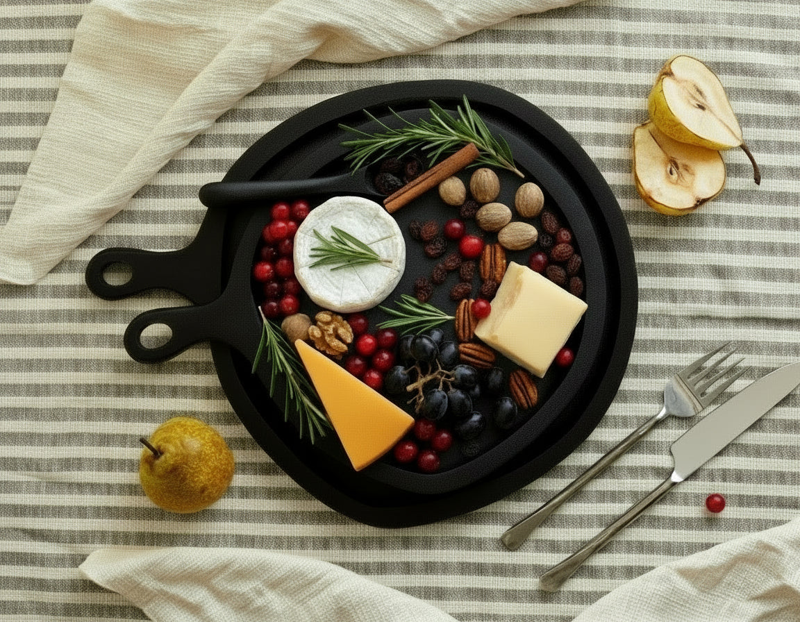 Black wood round serving board set with serving spoon styled with cheese and cranberries