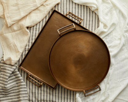 Brontë Bronze rustic serving tray UK styled with linen underneath, round tray
