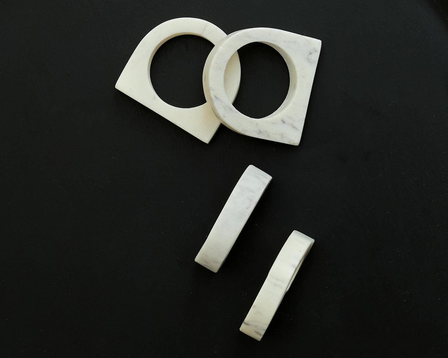 Chelsea Marble Napkin Rings polished natural stone set displayed on black background