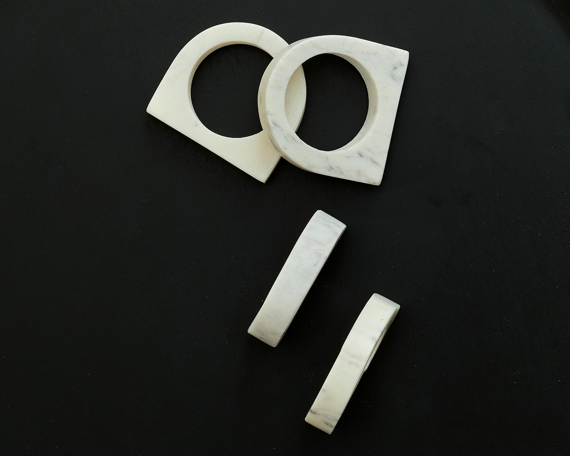 Chelsea Marble Napkin Rings polished natural stone set displayed on black background