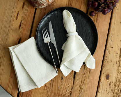 Chelsea Marble Napkin Rings polished natural stone set displayed on black plate with cutlery