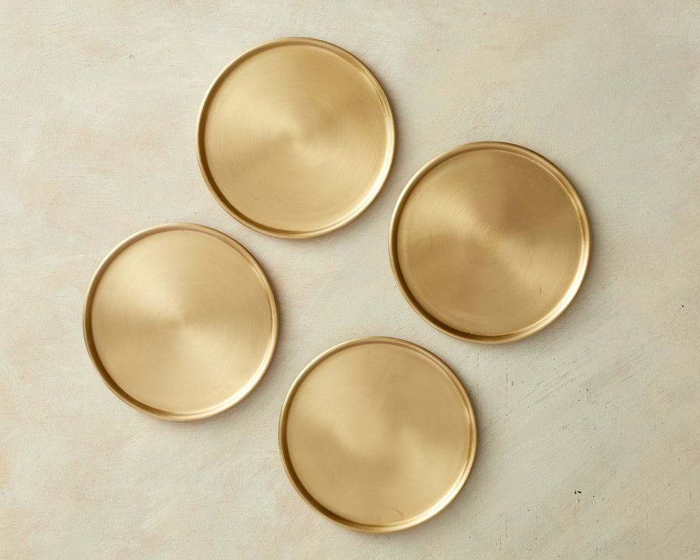 Brass coasters handcrafted tableware separated country house table UK
