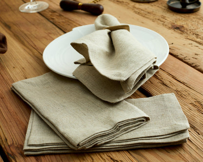 Close-up of beige linen table napkin on a rustic farmhouse place setting