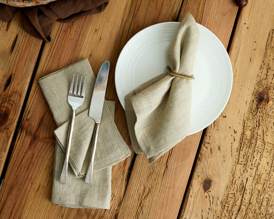 Beige linen table napkin on a rustic farmhouse table place setting