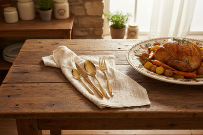 Gold cutlery set beside farmhouse Sunday roast countryside kitchen UK