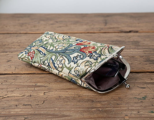 Golden Lily glasses pouch in William Morris tapestry styled on rustic wooden tabletop with warm tones and heritage-inspired countryside charm