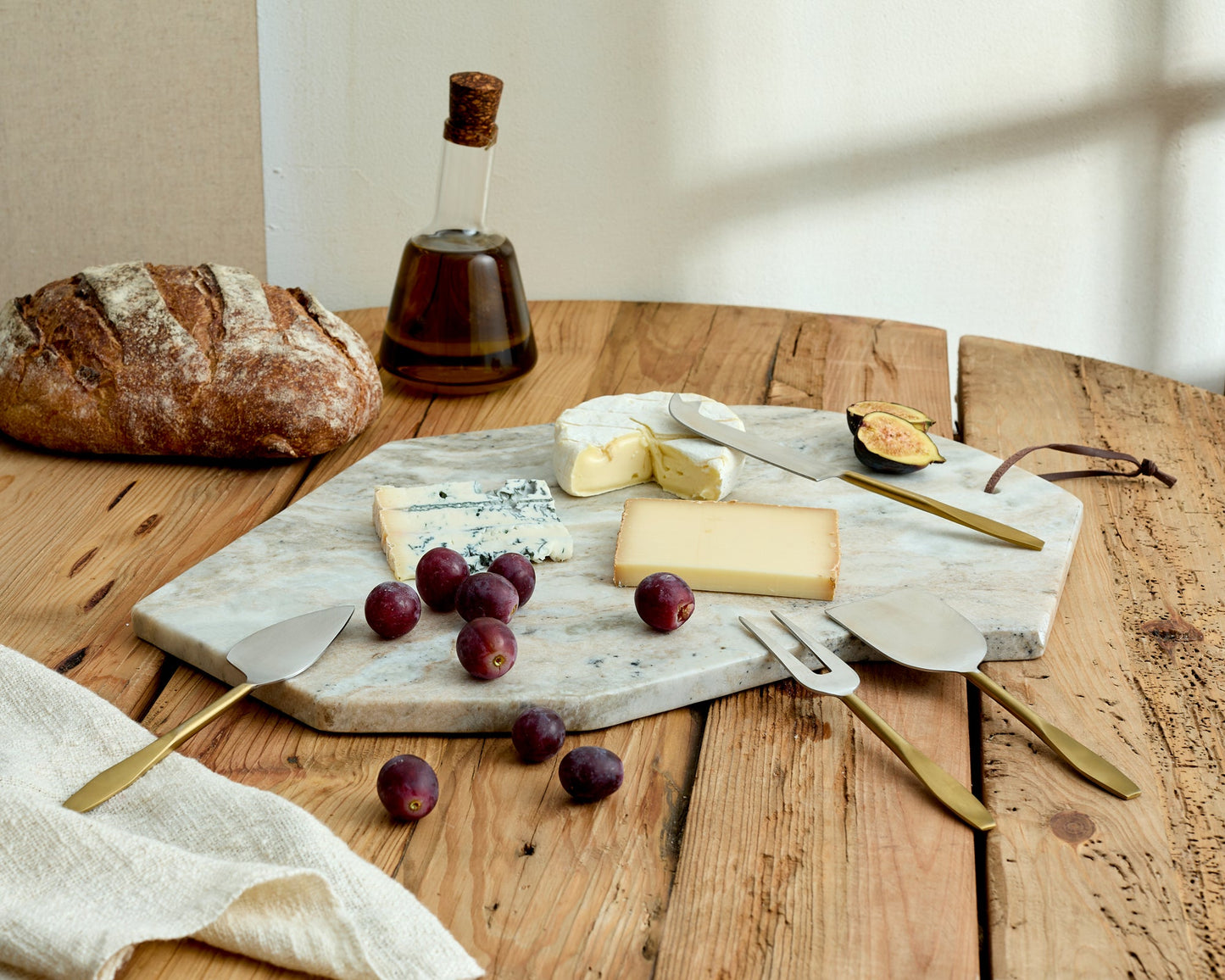 Hartley Torrent marble serving board artisan platter styled with cheese, grapes, bread and linen
