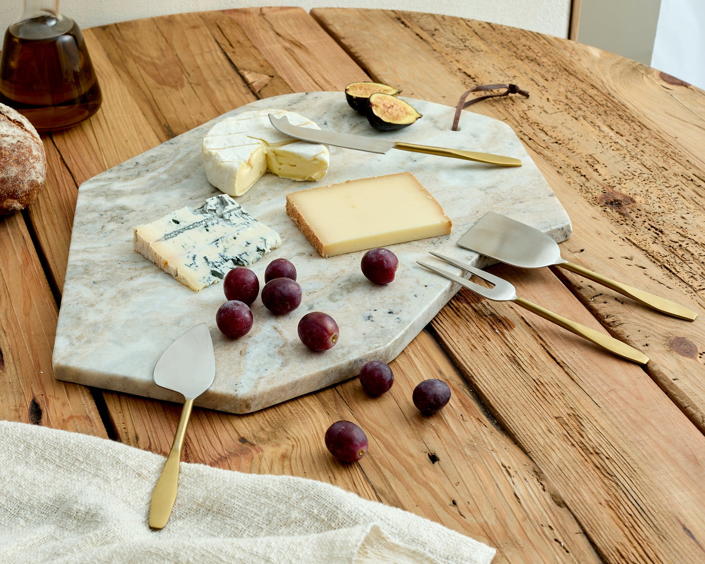 Hartley Torrent marble serving board artisan platter for entertaining photographed from another angle on table
