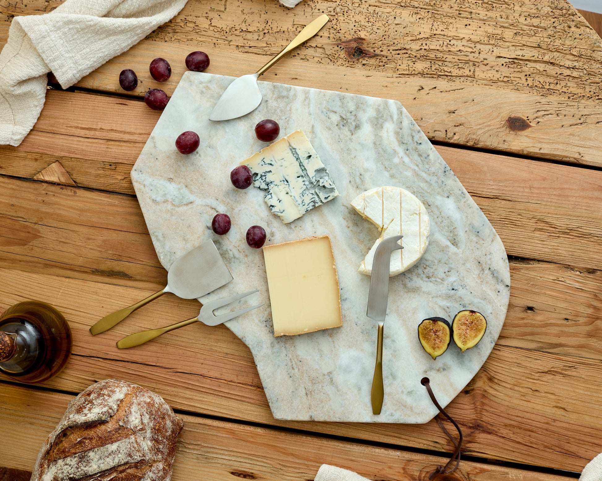 Hartley Torrent marble serving board artisan platter for entertaining viewed from above on wooden table

