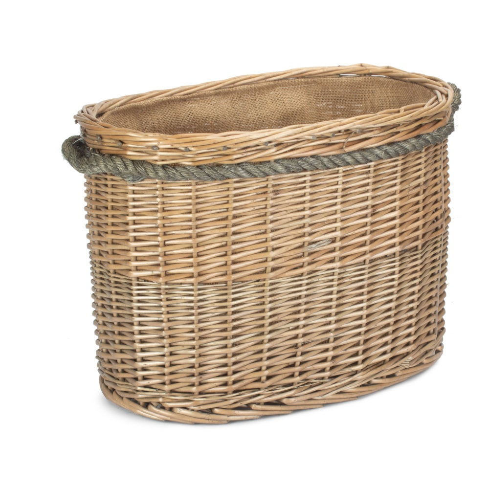 Oval wicker log basket rope handles cosy country cottage sitting room cat rug fireside UK
