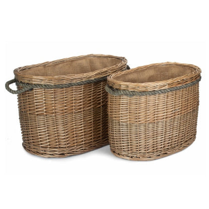 Oval wicker log basket rope handles plain background handwoven fireside storage UK
