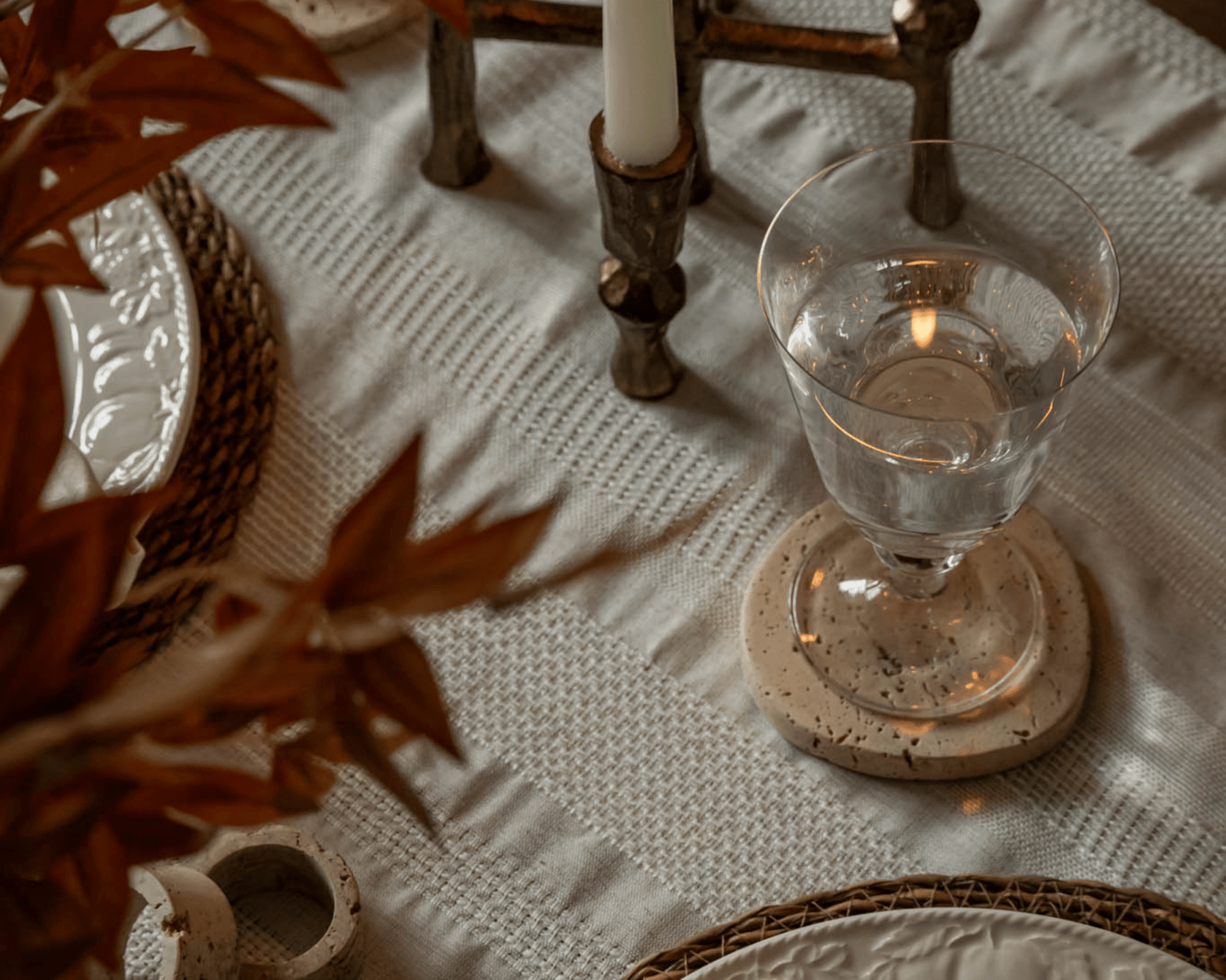 Heritage travertine coasters styled on countryside dining table UK timeless homeware elegance