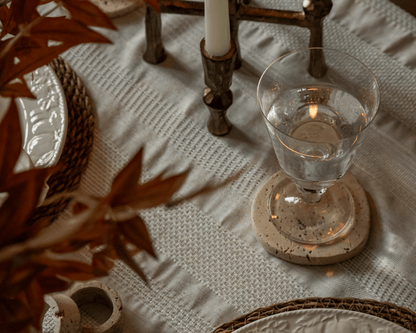 Heritage travertine coasters styled on countryside dining table UK timeless homeware elegance