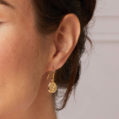 Laura Ashley Farlington Flowers gold plated hook earrings on model UK
