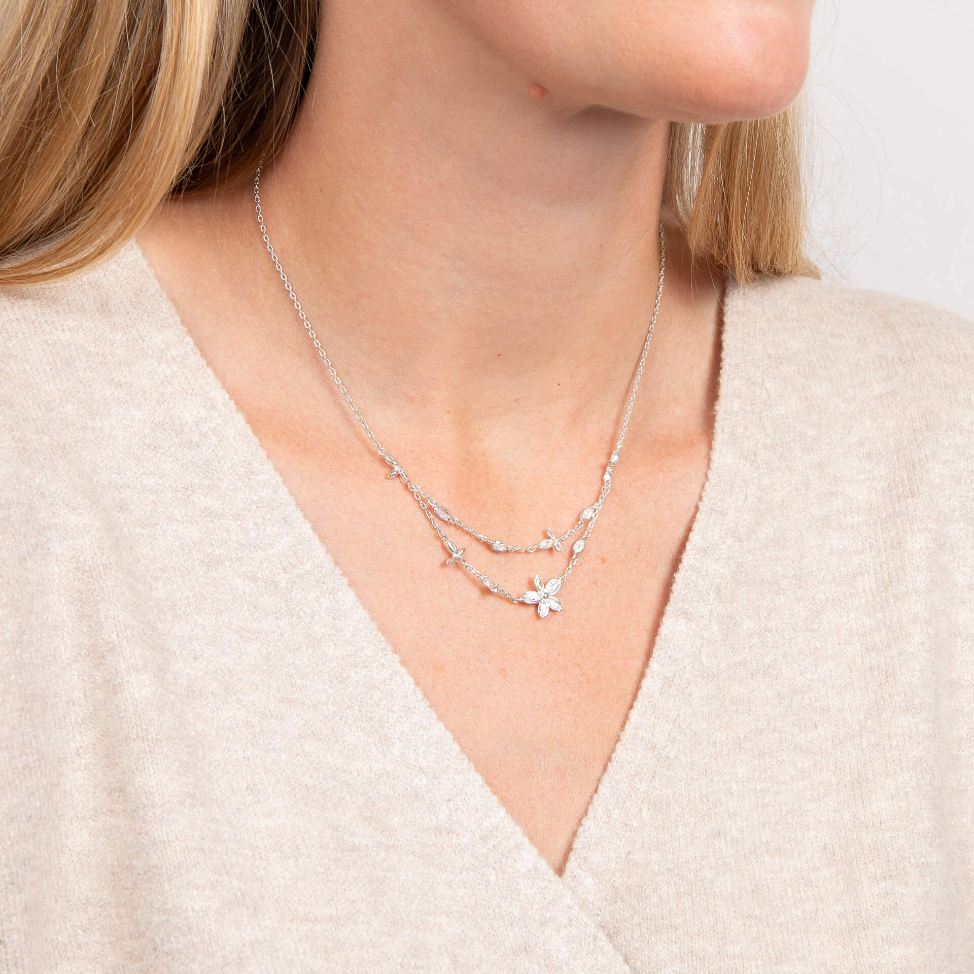 Laura Ashley Tumbling Floral necklace on model collarbone silver plated UK