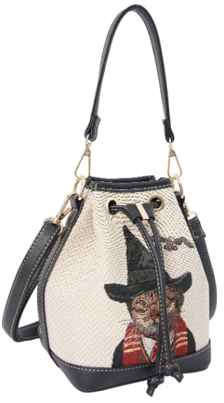 Side view of magical cat tapestry bucket bag with vegan leather trim on plain blank background