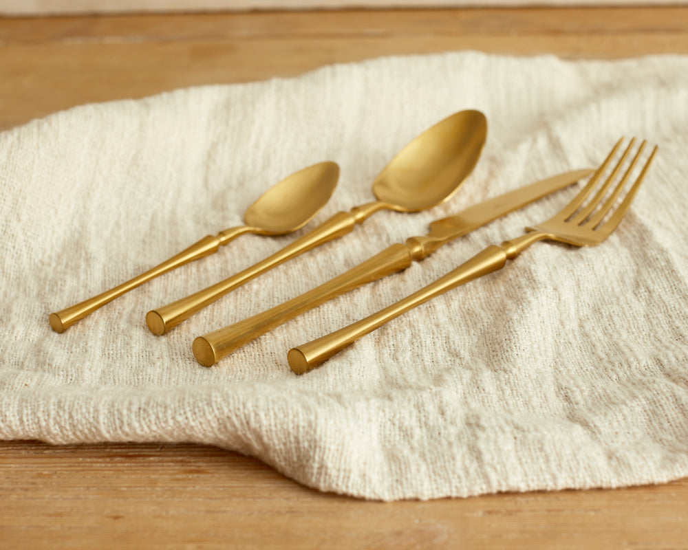 Matte gold cutlery set 16 piece stainless steel flatware on linen UK