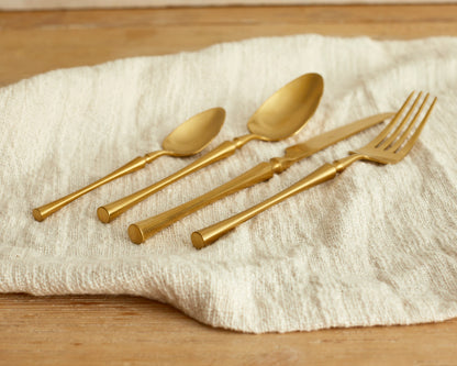 Matte gold cutlery set 16 piece stainless steel flatware on linen UK