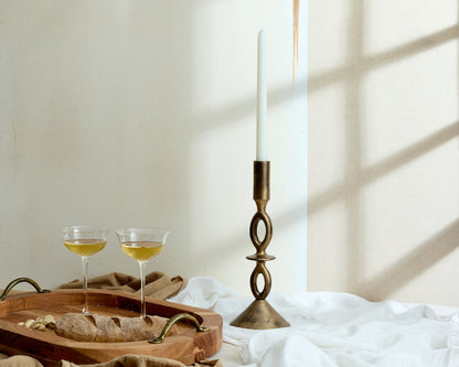 Oval fir wood tray Branlow Hearth Tray styled in window light with cocktail glasses, bread and brass candle holder
