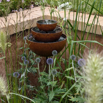 Rusted garden fountain stake rain catcher three-tier bowls purple thistle cottage garden UK