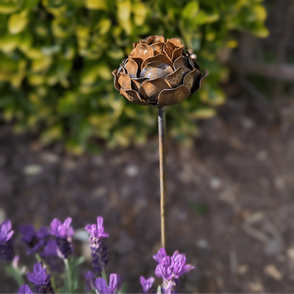 Rusted peony garden stake 100cm tall among purple flowers green foliage cottage garden UK
