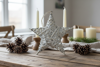 Whitewashed wicker star ornament resting on a festive table with candles and greenery