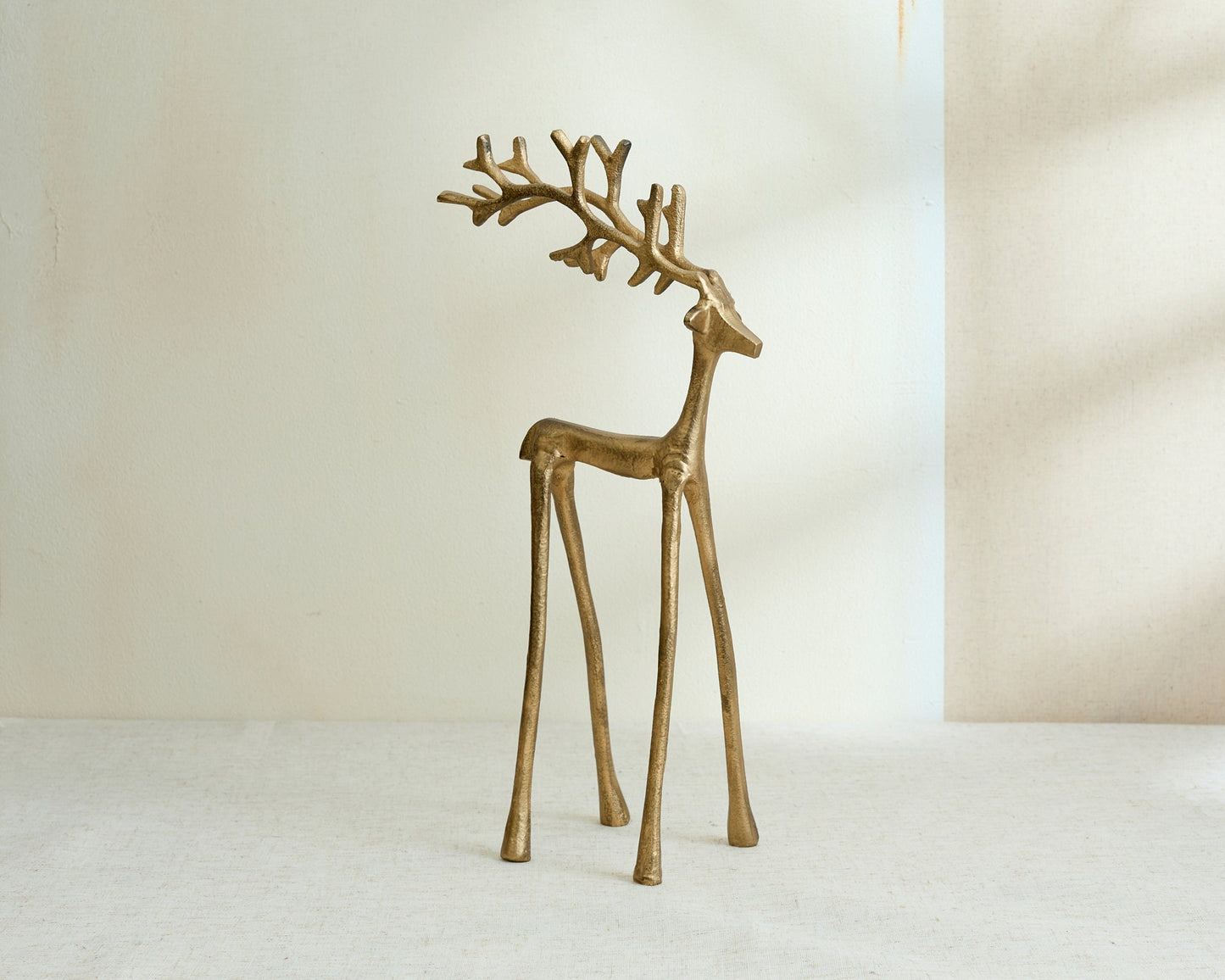 Wickham gold reindeer ornament festive mantel decor UK displayed on its own from another angle
