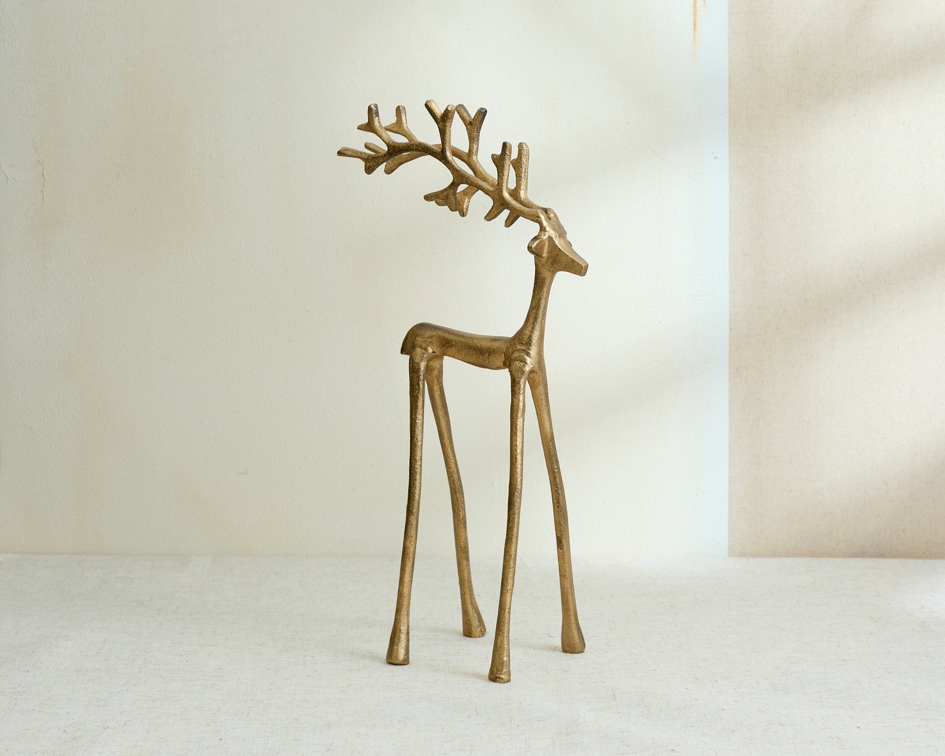 Wickham gold reindeer ornament festive mantel decor UK displayed on its own from another angle
