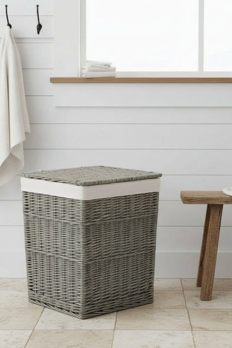 Square wicker laundry basket antique wash in cottage bathroom with white cotton lining

