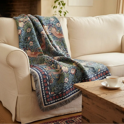 William Morris Strawberry Thief blue throw UK draped on heritage cottage sofa living room
